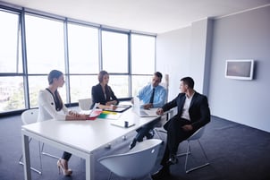 Group of happy young  business people in a meeting at office