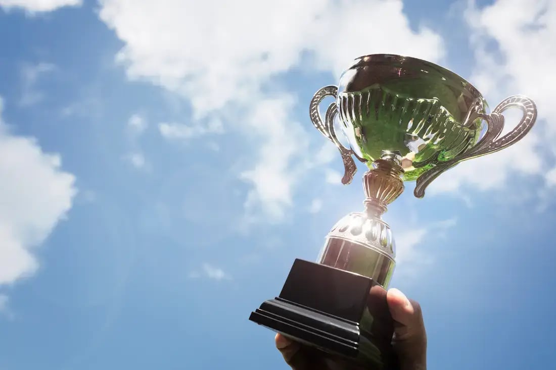 holding-up-a-trophy-cup-as-a-winner-2024-09-13-00-14-34-utc