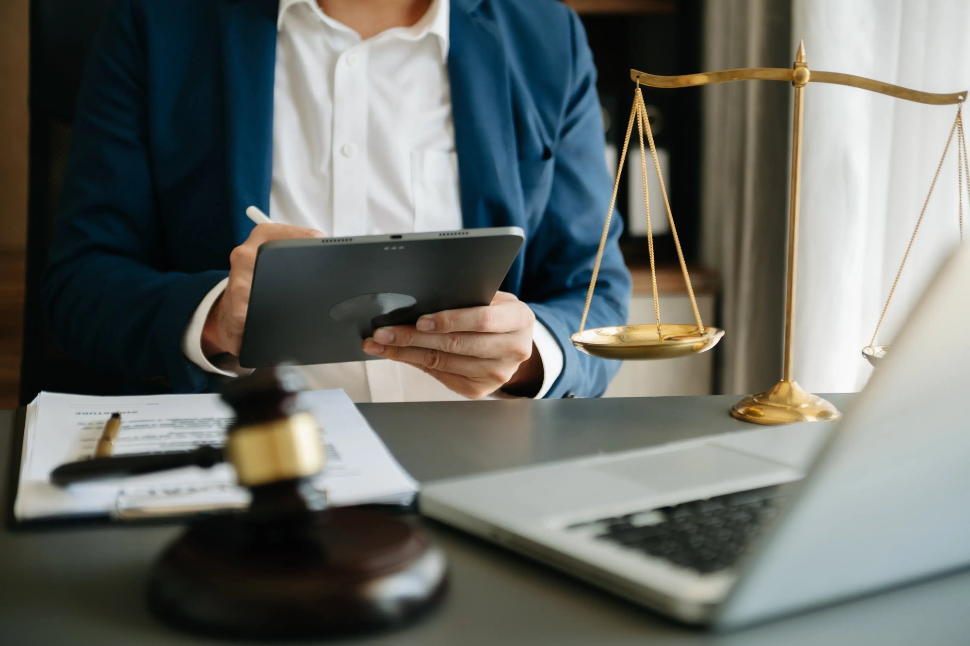 legal-professional-using-tablet-at-desk-with-scale-2026-01-08-22-50-16-utc legal-professional-using-tablet-at-desk-with-scale-2026-01-08-22-50-16-utc